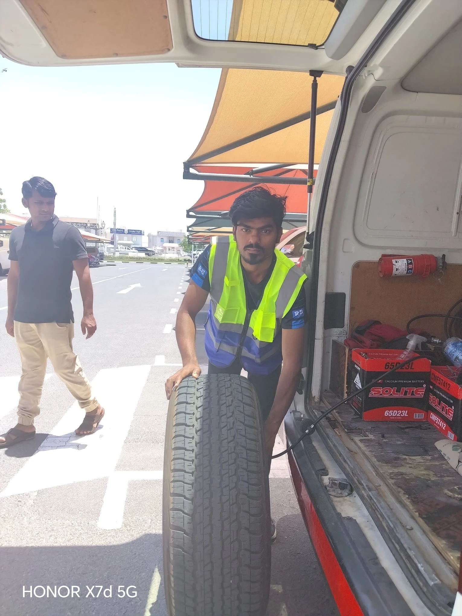 Technician repairing a punctured tyre roadside in Qatar